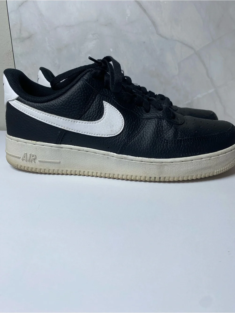 Nike Black Leather Sneakers with White Swoosh.